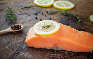 raw salmon with lemon herb black pepper prepare for cook on wooden background 