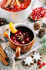 Mulled wine,punch,bowl oder spiced fruits tea : winter traditional warming drinks with spicy,citrus fruits and pomegranate . Rustic style.Selective focus 