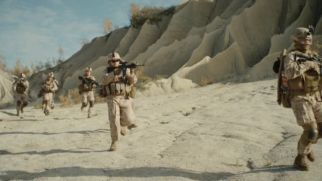  Squad of Fully Equipped, Armed Soldiers Running in the Desert. Shot on RED EPIC Cinema Camera in 4K (UHD).