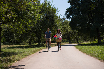 Fototapeta premium Young multiethnic couple having a bike ride in nature