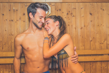 Loving couple having fun in the sauna