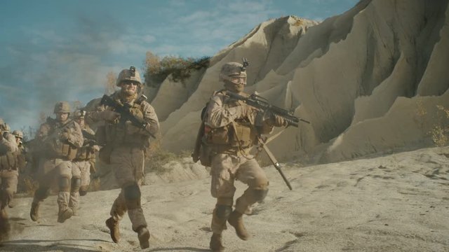  Squad of Fully Equipped, Armed Soldiers Running and Attacking During Military Operation in Desert. Slow Motion. Shot on RED EPIC Cinema Camera in 4K (UHD).
