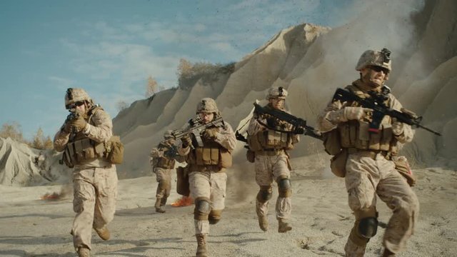  Squad of Fully Equipped, Armed Soldiers Running and Attacking During Military Operation in the Desert. Slow Motion. Shot on RED EPIC Cinema Camera in 4K (UHD).
