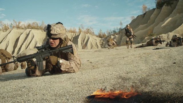  Squad of Fully Equipped and Armed Soldiers Crawling During Military Operation in the Desert. Slow Motion. Shot on RED EPIC Cinema Camera in 4K (UHD).