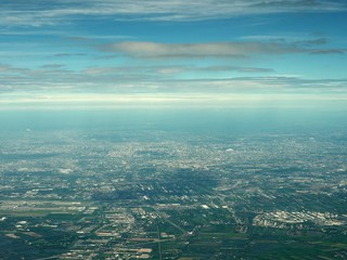 aerial view of clouds and village landscape