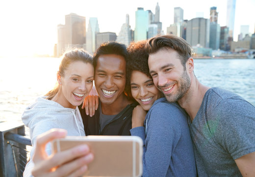 Friends taking selfie picture on Brooklyn heights promenade, NYC