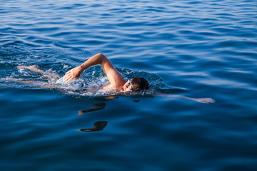 Man swimming in blue water