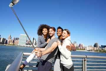 Group of friends taking selfie picture, Manhattan in background