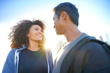 Couple enjoying scenery of Manhattan from Brooklyn Heights at sunset