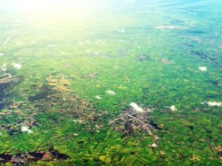 Aerial view of clouds and village landscape. View from aircraft window.