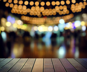 image of wooden table in front of abstract blurred background