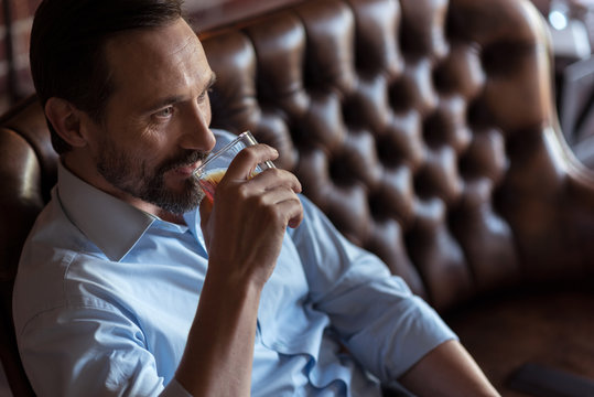 Joyful Optimistic Man Taking A Sip