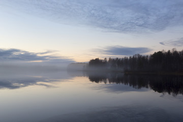 Fototapeta na wymiar Silent foggy evening in Finland. Calm waters, cold night. Beautiful and silent.