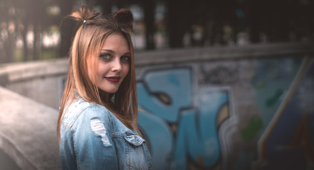 young girl with red lips posing in a denim jacket