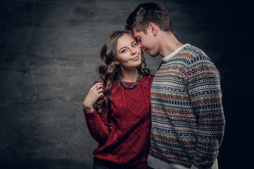 Urban couple in warm autumn sweaters.