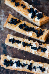 Black caviar on a toast with butter