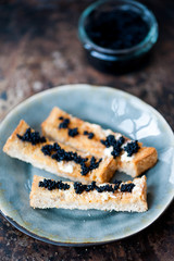 Black caviar on a toast with butter