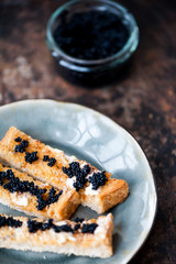 Black caviar on a toast with butter