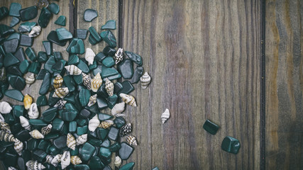 Malachite on wooden background, small shells on a wooden backgro