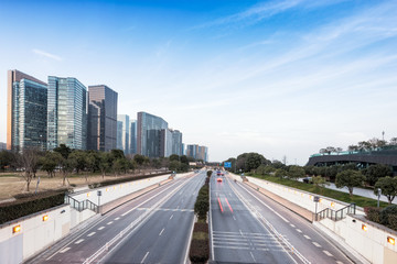 Fototapeta na wymiar traffic on road and modern buildings in hangzhou