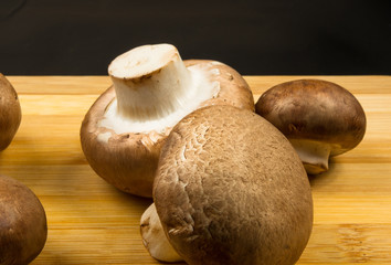 mushroom champignons on a wooden Board