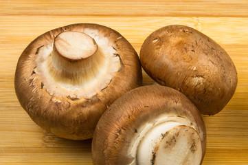 mushroom champignons on a wooden Board