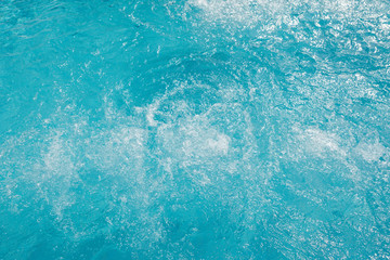 Ripple Water in swimming pool with sun reflection