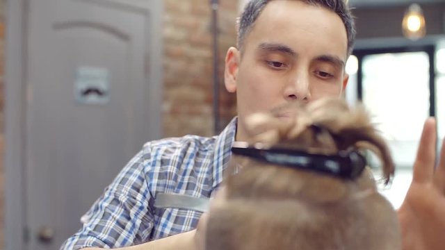 master Barber shaves a customer businessman with a straight razor