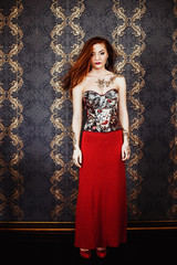beautiful girl with red hair posing in Studio