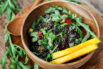 Organic salad with quinoa, arugula and mango
