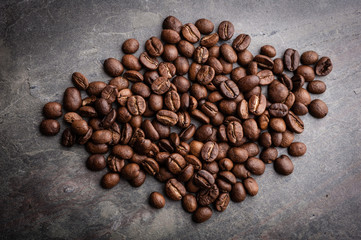 Coffee beans on grunge stone background