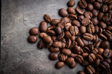 Coffee beans on grunge stone background