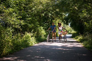 Obraz premium Young multiethnic couple having a bike ride in nature