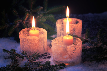 Obraz na płótnie Canvas burning candles on a winter background