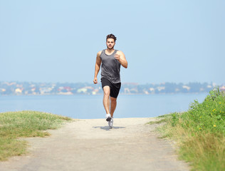 Man jogging on river background