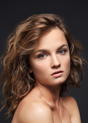 Fototapeta premium Portrait of beautiful young woman with long hair on grey background
