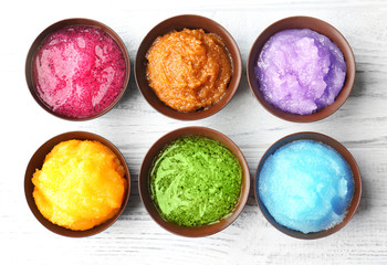 Body scrubs on wooden background