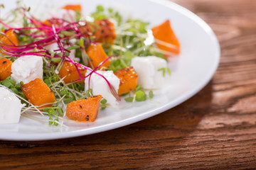 Salad with roasted pumpkin, cheese and herbs mini