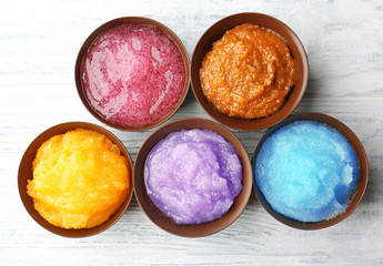 Body scrubs on wooden background