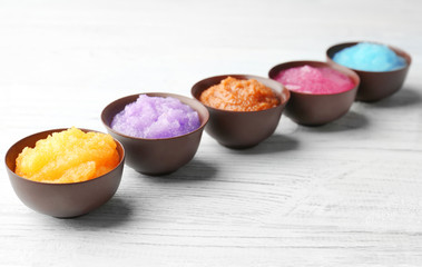 Body scrubs on wooden background