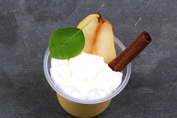 dessert of pears and cinnamon on a stone background