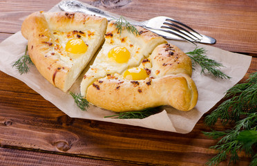 Khachapuri, baked with quail eggs and cheese