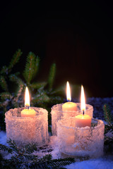 burning candles on a winter background