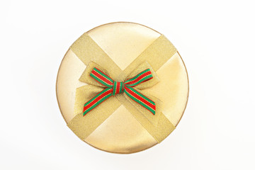 Round golden gift box with ribbon and bow isolated