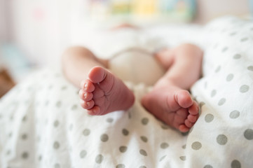 Close up, legs of unrecognizable newborn baby boy
