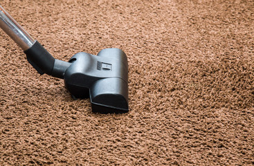 Professional vacuum cleaner turbo brush frees the carpet from dust. Early spring cleaning or...