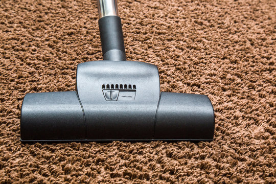 Professional vacuum cleaner turbo brush frees the carpet from dust. Early spring cleaning or regular clean up.
