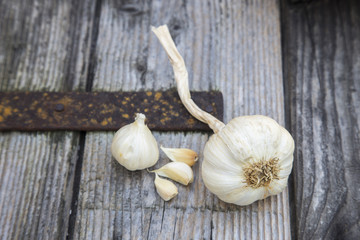 cloves of garlic on the wood background.