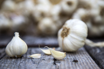cloves of garlic on the wood background.