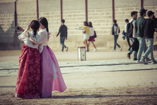 Young girls in traditional dresses at Gyeongbokgung Palace of Seoul, South Korea.
